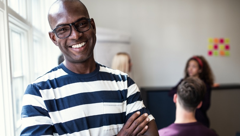 smiling-african-designer-standing-in-an-office-aft-2023-11-27-05-29-58-utc